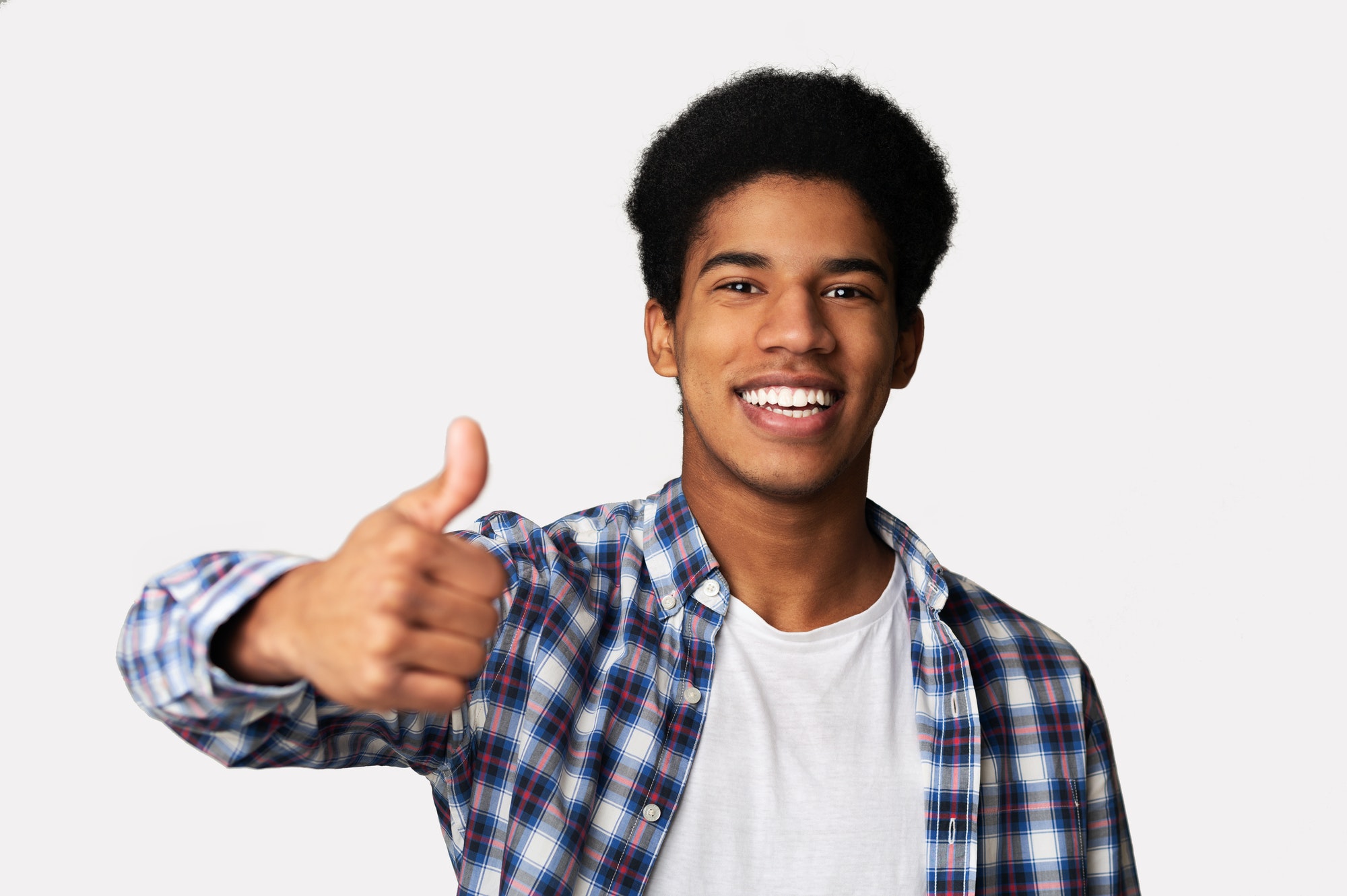 Overjoyed african guy showing thumb up at studio